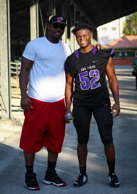 Khalil Mack posing with his younger brother LeDarius Mack in his football dress.